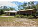 A single-story house with a metal carport and landscaping at 9365 Lemon Dr, Lake Wales, FL 33898