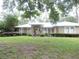 Charming single-story home featuring stone accents, arched windows and a well-manicured lawn and landscaping at 9365 Lemon Dr, Lake Wales, FL 33898