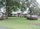 Charming single-story house featuring arched windows, stone detailing, and a well-maintained lawn at 9365 Lemon Dr, Lake Wales, FL 33898