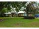 Charming ranch-style home with a lush green lawn and mature trees, offering a serene and inviting curb appeal at 9365 Lemon Dr, Lake Wales, FL 33898