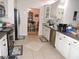 Functional kitchen with stainless steel appliances, white cabinetry, and tile flooring at 9365 Lemon Dr, Lake Wales, FL 33898