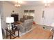 Cozy living room featuring hardwood floors, a fireplace, comfortable seating, and natural light at 9365 Lemon Dr, Lake Wales, FL 33898