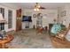 Cozy living room with hardwood floors, ceiling fan, fireplace, and plenty of seating at 9365 Lemon Dr, Lake Wales, FL 33898