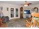 Cozy living room with hardwood floors, ceiling fan, fireplace, and plenty of seating at 9365 Lemon Dr, Lake Wales, FL 33898
