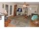 Cozy living room with hardwood floors, ceiling fan, fireplace, and plenty of seating at 9365 Lemon Dr, Lake Wales, FL 33898