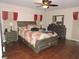This bedroom features hardwood floors, a ceiling fan, and plenty of closet space at 9365 Lemon Dr, Lake Wales, FL 33898