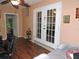Bright office area with french doors, ceiling fan, and wood laminate flooring at 9365 Lemon Dr, Lake Wales, FL 33898