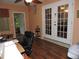 Office area with French doors, a ceiling fan, and wood laminate flooring at 9365 Lemon Dr, Lake Wales, FL 33898