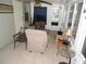 Bright sunroom with comfortable seating, paneled walls, and a ceiling fan at 9365 Lemon Dr, Lake Wales, FL 33898
