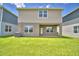 Backyard features a green lawn, partial patio, and the back of a two-story home at 1417 Leamington Ln, Winter Haven, FL 33884