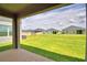 View of backyard featuring well maintained lawn and neighbor's home at 1417 Leamington Ln, Winter Haven, FL 33884