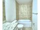 Bright bathroom with tiled shower and tub combo, featuring neutral color scheme at 1417 Leamington Ln, Winter Haven, FL 33884
