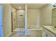 Bathroom features a tiled shower, a soaking tub, and a single sink at 1417 Leamington Ln, Winter Haven, FL 33884