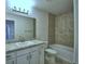 Bright bathroom featuring a single vanity, tub with tile surround, and modern fixtures at 1417 Leamington Ln, Winter Haven, FL 33884