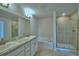 Bathroom with double sinks, bathtub and glass shower with tile surround at 1417 Leamington Ln, Winter Haven, FL 33884