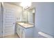 Bright bathroom featuring a granite countertop vanity, mirror, and neutral wall color at 1417 Leamington Ln, Winter Haven, FL 33884