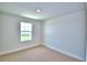 Minimalist bedroom with neutral carpet, a window offering natural light, and ample space at 1417 Leamington Ln, Winter Haven, FL 33884
