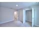 Spacious bedroom with plush carpet, neutral walls, closet, and doorway to additional room at 1417 Leamington Ln, Winter Haven, FL 33884