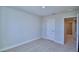 Bedroom with neutral color scheme, carpeted floor, closet and doorway to additional rooms at 1417 Leamington Ln, Winter Haven, FL 33884