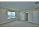 Bedroom with neutral carpet features a window with a view; bathroom door and closet door are visible at 1417 Leamington Ln, Winter Haven, FL 33884