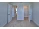 Bright bedroom with neutral walls, carpet, and multiple doors leading to other areas of the home at 1417 Leamington Ln, Winter Haven, FL 33884