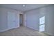 A spacious bedroom with plush carpet and a doorway leading to other parts of the house at 1417 Leamington Ln, Winter Haven, FL 33884