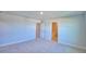 Bedroom with neutral carpet features a bathroom door with a tub in view at 1417 Leamington Ln, Winter Haven, FL 33884