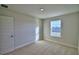 Cozy bedroom featuring a window providing natural light and plush carpeting for comfort at 1417 Leamington Ln, Winter Haven, FL 33884