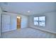 Neutral bedroom features recessed lighting and a window with a view; bathroom door is visible at 1417 Leamington Ln, Winter Haven, FL 33884