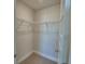 Walk-in closet with carpeted floor and wire shelving, ready for organized storage solutions at 1417 Leamington Ln, Winter Haven, FL 33884