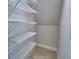 Walk-in closet featuring wire shelving, tile floors, and plenty of storage space at 1417 Leamington Ln, Winter Haven, FL 33884