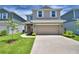 Charming two-story home with a well-manicured lawn, large driveway, and an inviting red door at 1417 Leamington Ln, Winter Haven, FL 33884