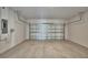 Spacious, empty two-car garage with concrete floor and overhead door; electrical panel on wall at 1417 Leamington Ln, Winter Haven, FL 33884