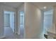 Hallway shot with open doors leading to carpeted bedrooms at 1417 Leamington Ln, Winter Haven, FL 33884