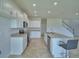 Bright kitchen features white cabinets, granite counters, stainless steel appliances, and a convenient center island at 1417 Leamington Ln, Winter Haven, FL 33884