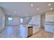 Kitchen island with a sink, stainless steel dishwasher and a view to a large living space at 1417 Leamington Ln, Winter Haven, FL 33884