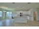 View of the kitchen with white cabinets, an island with a sink, and stainless steel appliances at 1417 Leamington Ln, Winter Haven, FL 33884