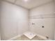 A practical laundry room with essential connections and minimalist shelving for optimal organization at 1417 Leamington Ln, Winter Haven, FL 33884