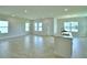 Expansive open-concept living room filled with natural light and featuring neutral tile flooring at 1417 Leamington Ln, Winter Haven, FL 33884