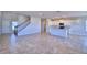 Open-concept living space featuring tile flooring and a kitchen with white cabinets and granite countertops at 1417 Leamington Ln, Winter Haven, FL 33884
