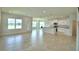 Open-concept living area featuring a dining area, and kitchen with white cabinets and tile floors at 1417 Leamington Ln, Winter Haven, FL 33884