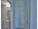 Powder room view showing entry door, pedestal sink, oval mirror, and neutral paint at 1417 Leamington Ln, Winter Haven, FL 33884