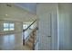 Staircase with carpet, wood banister, and open concept living with view of dining and living areas at 1417 Leamington Ln, Winter Haven, FL 33884