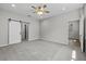 Bedroom featuring plush carpeting and a sliding barn door entrance to the bathroom at 4502 Fairway Oaks Dr, Mulberry, FL 33860