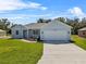 Charming home featuring a two-car garage, fresh landscaping, and a well-manicured lawn at 4502 Fairway Oaks Dr, Mulberry, FL 33860