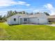 Single story home showcasing a lush green lawn, well-maintained garden, and a classic architectural style at 4502 Fairway Oaks Dr, Mulberry, FL 33860