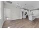 Bright kitchen with white cabinets, stainless steel appliances, island, and modern chandelier at 4502 Fairway Oaks Dr, Mulberry, FL 33860