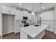 Stylish kitchen with white cabinets, stainless steel appliances, and a large center island at 4502 Fairway Oaks Dr, Mulberry, FL 33860
