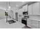 Kitchen featuring white cabinets, stainless steel appliances, island with a sink and pendant lighting at 4502 Fairway Oaks Dr, Mulberry, FL 33860