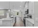 Modern kitchen featuring white cabinets, stainless steel appliances, and an island sink with seating at 4502 Fairway Oaks Dr, Mulberry, FL 33860